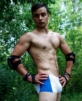 Roller skates young man in lycra shorts outdoor