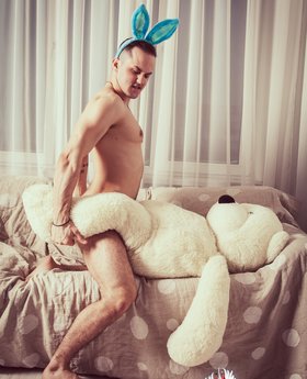 Sexy bunny man in love with his teddy bear