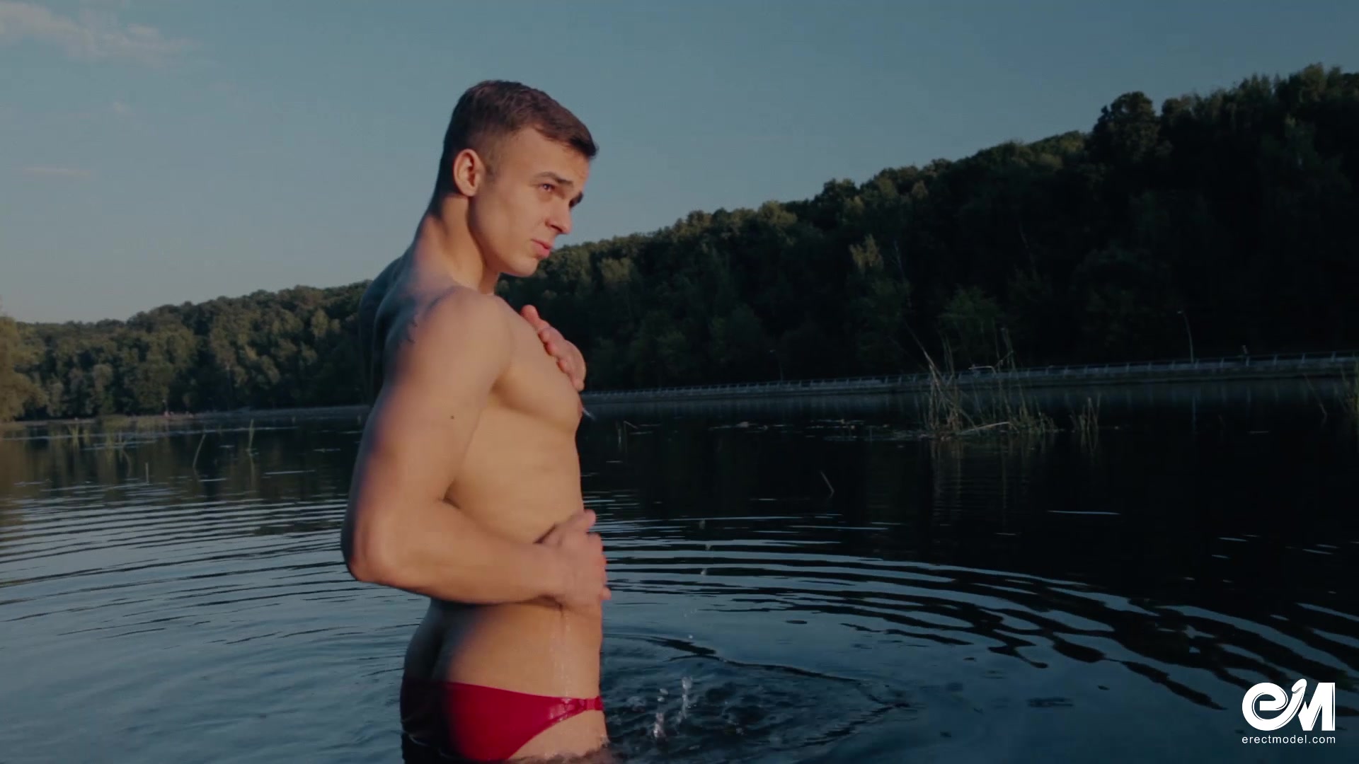 Cute teen boy stripping until naked in the river