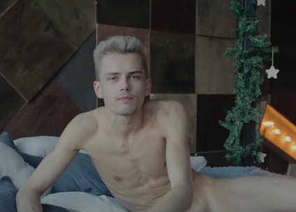Seductive twink stripping and playing with uncut cock
